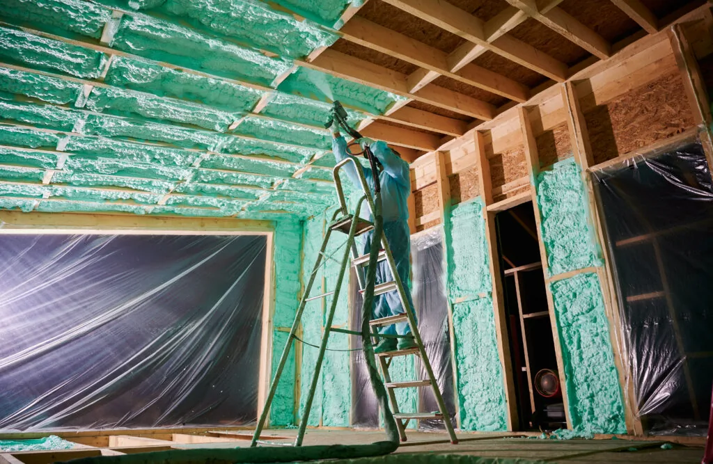 Rodent proofing spray foam — contractor sealing home gaps and cracks with polyurethane foam in Saskatchewan